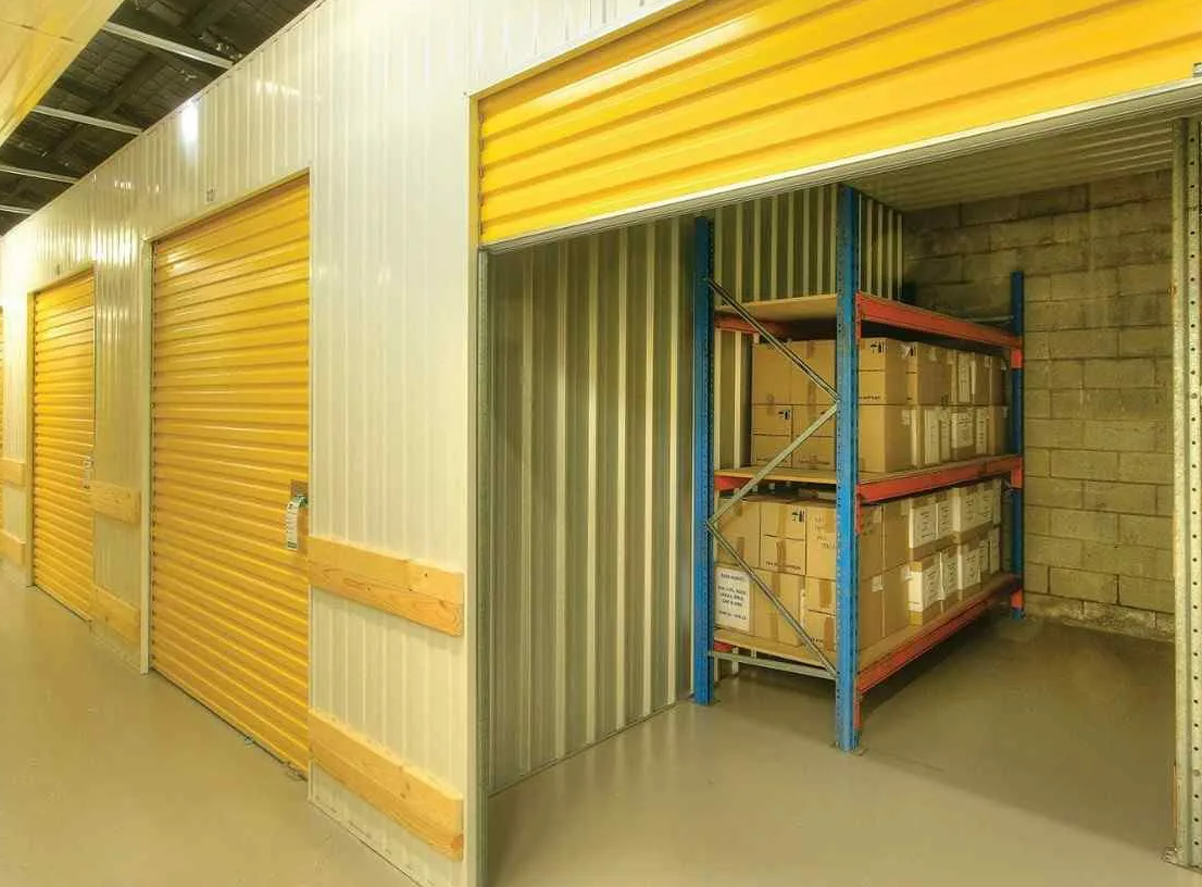 Business owner reviewing stock boxes in a storage unit