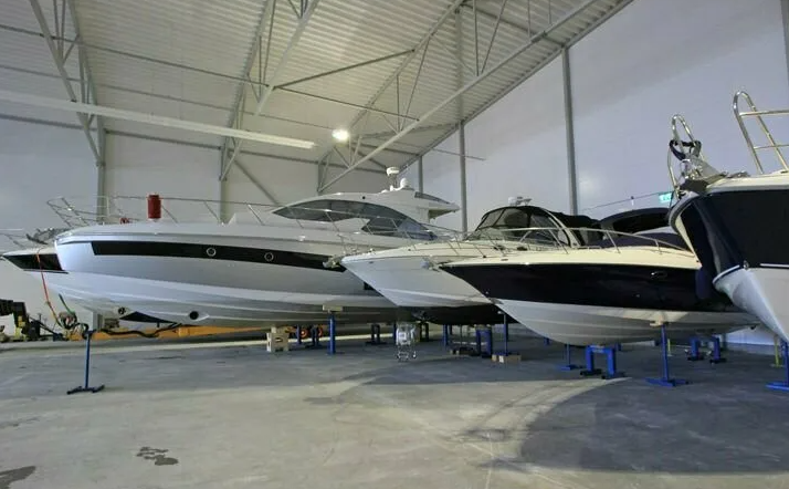 Luxury yacht secured inside a modern enclosed dock for winter storage